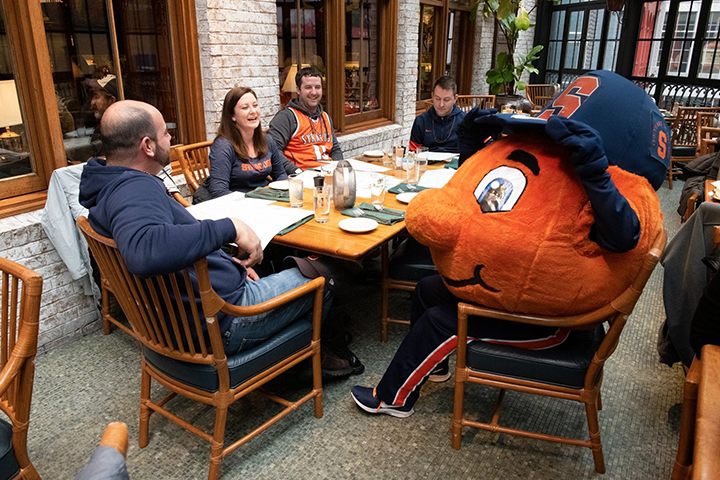 Otto sitting with fans at brunch