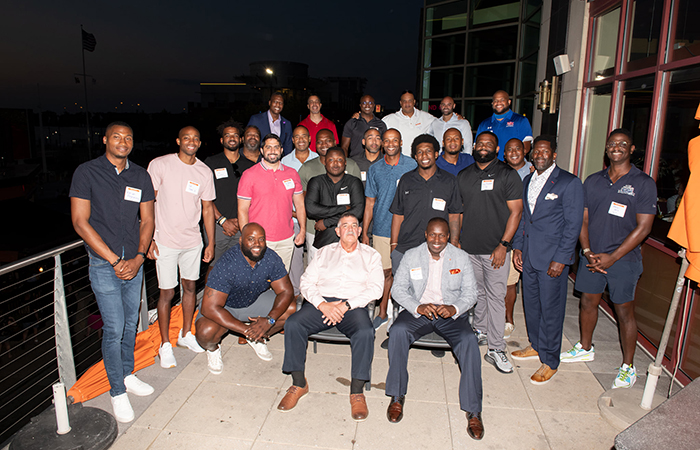 The group of football alumni pose for a photo at the end of the evening.